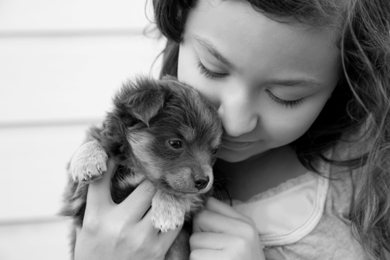 Girl embracing small dog